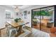 Inviting dining area with a farmhouse table, seating, and outdoor access to the backyard at 116 W Chelsea St, Tampa, FL 33603