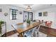 Charming dining room featuring a rustic table, stylish chairs, and sliding glass doors to backyard at 116 W Chelsea St, Tampa, FL 33603