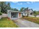 Charming home featuring well-manicured lawn, colorful front door, and spacious driveway at 116 W Chelsea St, Tampa, FL 33603