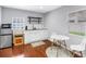 Bright kitchen with white cabinets, stainless steel appliances, and cozy dining area at 116 W Chelsea St, Tampa, FL 33603