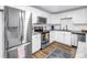 Modern kitchen with stainless steel appliances, white cabinets, and granite countertops at 116 W Chelsea St, Tampa, FL 33603