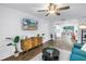 Stylish living room showcasing wood floors, modern furniture, and seamless flow to kitchen at 116 W Chelsea St, Tampa, FL 33603