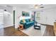 Cozy living room featuring a comfortable blue sofa, stylish decor, and a view of the window at 116 W Chelsea St, Tampa, FL 33603