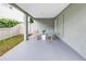 Cozy outdoor patio with comfortable seating for relaxation and a view of green space at 116 W Chelsea St, Tampa, FL 33603