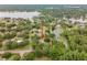 Expansive aerial view of the property showcasing lush greenery and surrounding lake at 1204 Ballinger Rd, Lutz, FL 33548