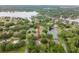 Aerial view of a home with mature trees near a private pond offering a peaceful and private residential setting at 1204 Ballinger Rd, Lutz, FL 33548