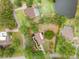 Aerial view of backyard landscape, with surrounding mature trees and nearby properties at 1204 Ballinger Rd, Lutz, FL 33548