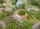 Beautiful aerial view of home with landscaping, lake, and mature trees on a spacious lot, perfect for outdoor living at 1204 Ballinger Rd, Lutz, FL 33548