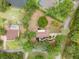 Expansive aerial view showcases a charming single-Gathering home surrounded by lush trees and landscaping at 1204 Ballinger Rd, Lutz, FL 33548