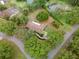 Aerial view of backyard area, highlighting the lush trees and landscaping at 1204 Ballinger Rd, Lutz, FL 33548