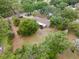 Aerial view of property featuring well-maintained landscaping and lush, mature trees at 1204 Ballinger Rd, Lutz, FL 33548