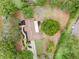 Overhead view shows home on a large lot featuring a long driveway and plenty of surrounding trees at 1204 Ballinger Rd, Lutz, FL 33548