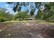 Expansive backyard with mature trees providing ample shade and privacy at 1204 Ballinger Rd, Lutz, FL 33548