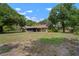 Lush backyard featuring a covered patio perfect for outdoor relaxation and entertaining at 1204 Ballinger Rd, Lutz, FL 33548