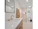 Bathroom featuring a modern sink with cabinets and tiled shower with glass door at 1204 Ballinger Rd, Lutz, FL 33548