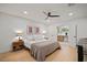 Bright bedroom featuring a neutral color scheme, ceiling fan, and en-suite bathroom at 1204 Ballinger Rd, Lutz, FL 33548