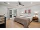 Bedroom with wooden floors, and light from double doors leading to the outside at 1204 Ballinger Rd, Lutz, FL 33548