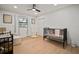A Bedroom featuring a dark metal crib, a changing table and wood floors at 1204 Ballinger Rd, Lutz, FL 33548