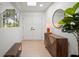Stylish entryway with wood floors, modern lighting, and a decorative cabinet at 1204 Ballinger Rd, Lutz, FL 33548