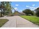 Charming single-story home with a lush front yard, long driveway and mature trees at 1204 Ballinger Rd, Lutz, FL 33548
