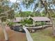 Attractive home featuring a landscaped front yard with mulch beds and mature trees at 1204 Ballinger Rd, Lutz, FL 33548
