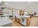 Spacious kitchen with quartz countertops, stainless steel appliances, and view of the open floorplan at 1204 Ballinger Rd, Lutz, FL 33548