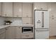 Neutral toned kitchen features stainless steel appliances, quartz countertops, and custom cabinets at 1204 Ballinger Rd, Lutz, FL 33548