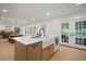 Kitchen island with quartz countertops, stainless steel sink, and seating for four at 1204 Ballinger Rd, Lutz, FL 33548