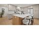 Kitchen features large island, quartz countertops, stainless steel appliances, and a neutral color scheme at 1204 Ballinger Rd, Lutz, FL 33548