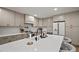 Kitchen featuring quartz countertops, stainless steel appliances, island with seating, and custom cabinetry at 1204 Ballinger Rd, Lutz, FL 33548