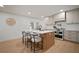 Bright kitchen featuring stainless steel appliances, quartz countertops, and views to the backyard at 1204 Ballinger Rd, Lutz, FL 33548