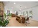 Open-concept living space with dining table, brick fireplace, and lots of natural light at 1204 Ballinger Rd, Lutz, FL 33548