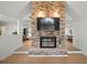 View of brick fireplace and tv in living room with open floorplan and neutral colors at 1204 Ballinger Rd, Lutz, FL 33548