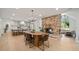Open-concept kitchen with dining table, chairs, and a brick fireplace at 1204 Ballinger Rd, Lutz, FL 33548