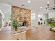 Bright open-concept living area featuring brick fireplace and lots of natural light at 1204 Ballinger Rd, Lutz, FL 33548