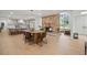 Open-concept living space with brick fireplace, dining area, and modern kitchen at 1204 Ballinger Rd, Lutz, FL 33548