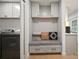 Mudroom featuring cabinets, drawers, a bench, pillows and laundry machines in the distance at 1204 Ballinger Rd, Lutz, FL 33548