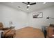 Bright home office with wood floors, an accent wall decoration, a ceiling fan and comfortable seating at 1204 Ballinger Rd, Lutz, FL 33548