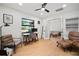 Bright home office with a large window, ceiling fan, and comfortable seating arrangement at 1204 Ballinger Rd, Lutz, FL 33548