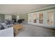 Expansive covered patio with grill, outdoor seating, and french doors to the home's interior at 1204 Ballinger Rd, Lutz, FL 33548