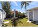Cozy backyard featuring a patio set, lush greenery, and mature trees for enjoying outdoor living at 12307 Villager Ct, Tampa, FL 33625