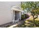 Welcoming entryway with a secure front door and well-manicured landscaping, adding curb appeal at 12307 Villager Ct, Tampa, FL 33625