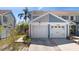 Charming townhome featuring a well-maintained facade with attached garages and landscaped surroundings at 12307 Villager Ct, Tampa, FL 33625