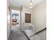 Cozy hallway featuring a carpeted floor, tapestry, and natural light, creating a warm and inviting transition between spaces at 12307 Villager Ct, Tampa, FL 33625