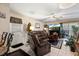 Inviting living room with leather furniture, tile flooring, and a view to the outside, ideal for relaxation at 12307 Villager Ct, Tampa, FL 33625