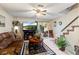 Comfortable living room with leather seating, tiled floors, and a view to the outside, perfect for relaxation at 12307 Villager Ct, Tampa, FL 33625