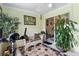 Bright sunroom featuring a seating area, exercise equipment, and sliding glass doors to the home's interior at 12307 Villager Ct, Tampa, FL 33625