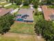 Spacious backyard with lush green grass, a screened-in pool, and a black fence surrounding the property at 12309 Creek Edge Dr, Riverview, FL 33579