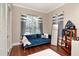 Cozy sitting room with a blue couch and large windows providing natural light at 12309 Creek Edge Dr, Riverview, FL 33579