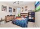 Bedroom features wood furnishings, neutral carpeting, with shelving and artwork at 12309 Creek Edge Dr, Riverview, FL 33579